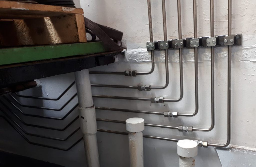 Stainless steel hydraulic piping, rerouted and replacing original steel piping